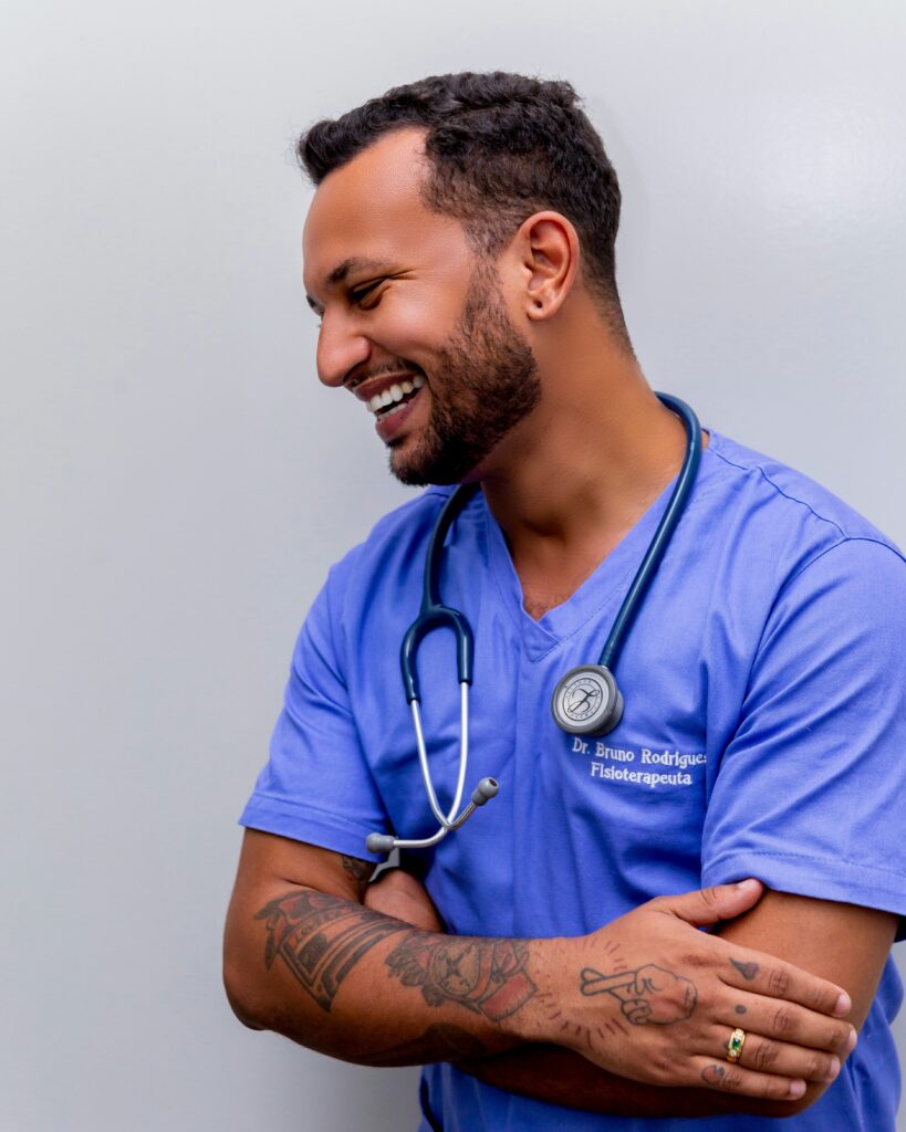 Male veterinarian in blue scrubs with stethoscope